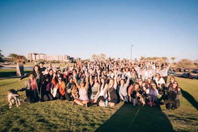Phoenix Babes Who Walk participants cheering for a group photo at a Waymo-sponsored morning walk